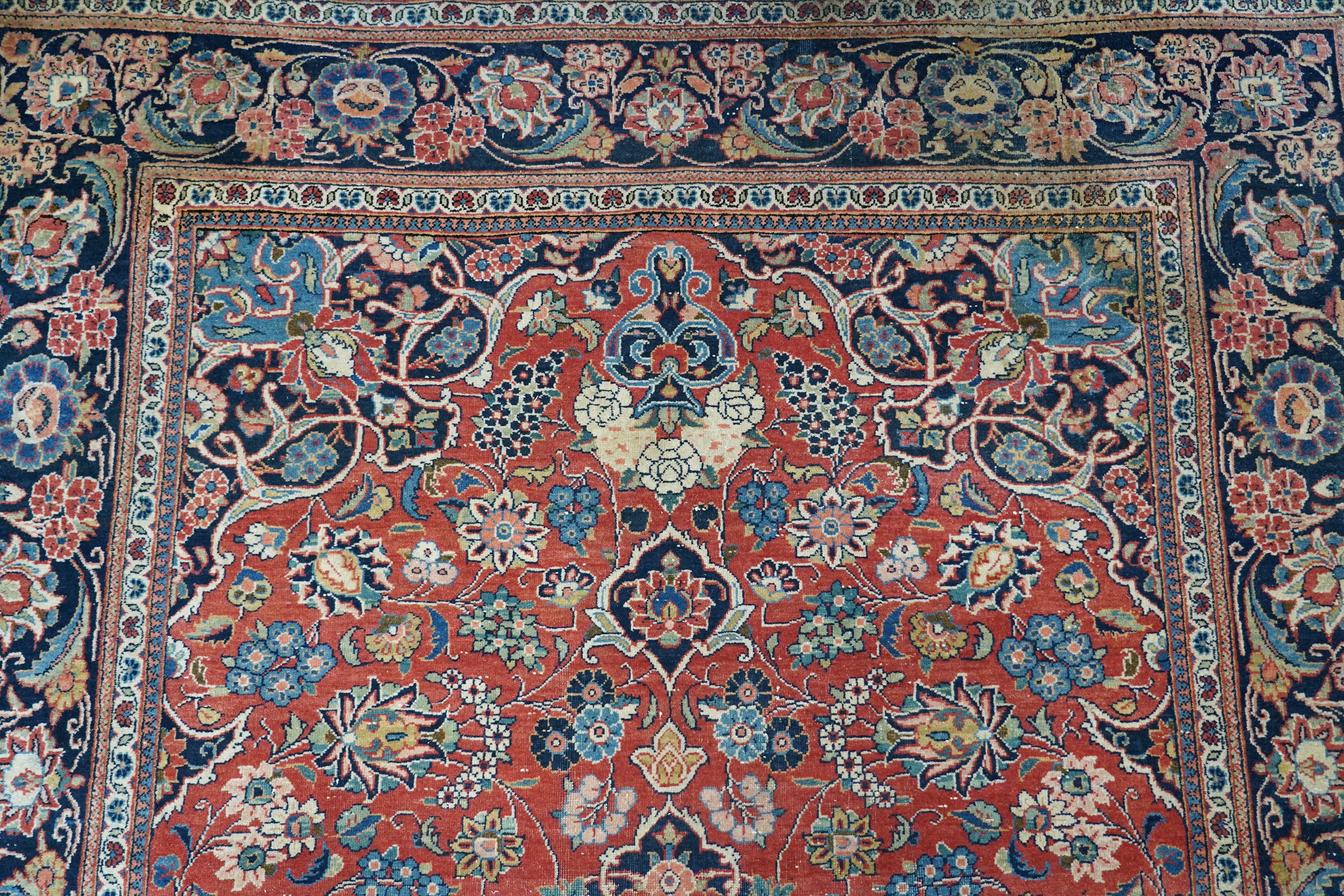 A pair of antique Tabriz brick red ground rugs, 200 x 136cm. Condition - fair